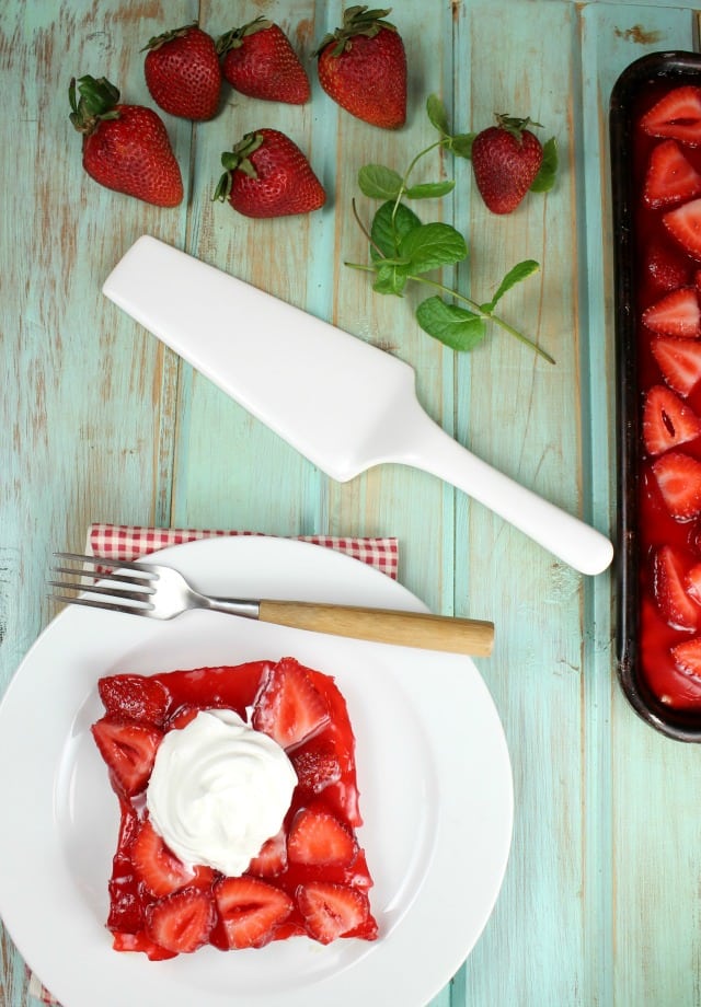 This Strawberry Slab Pie is a spin on my favorite fresh strawberry pie that my grandma made every summer. A fantastic dessert for any summer get together, barbecue or potluck! From MissintheKitchen.com