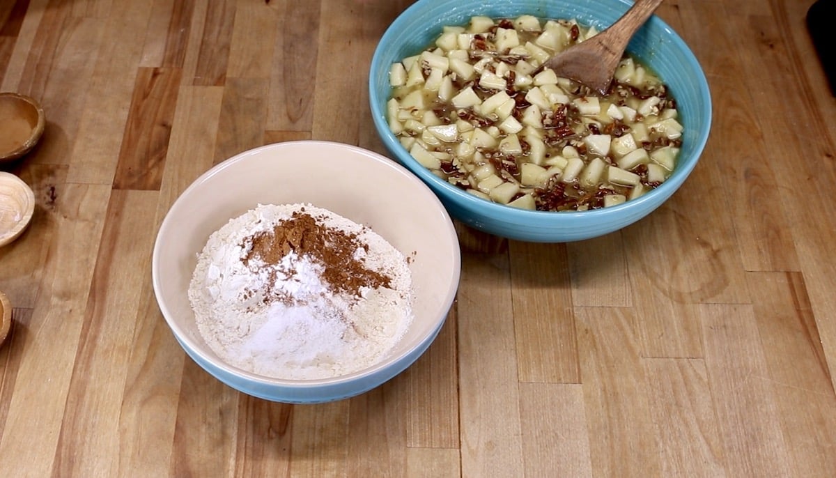 bowl with flour, cinnamon + bowl of chopped apples and pecans