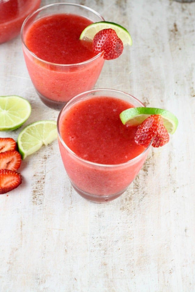 Easy Strawberry Daiquiri Cocktail garnished with limes and strawberries
