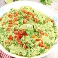 Roasted Garlic Guacamole is a delicious party appetizer or a must- have for taco night! From MissintheKitchen.com