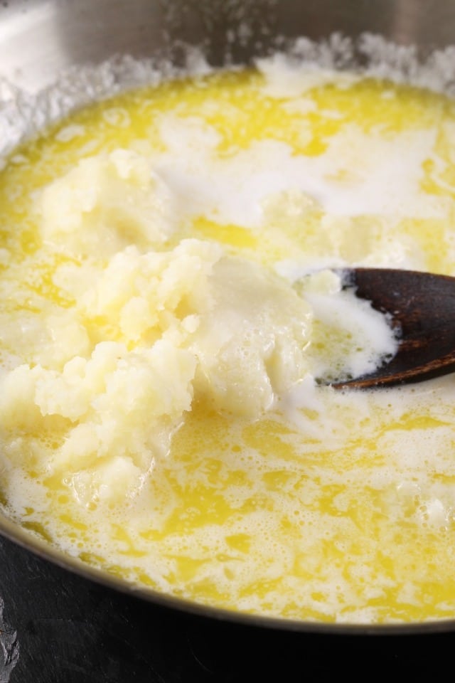 Adding mashed potatoes for White Cheddar Potato Rolls 