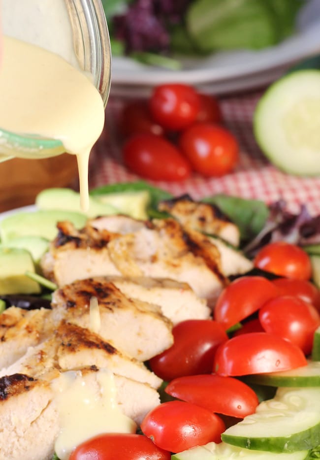 Pouring-Creamy-Citrus-Dressing-Over-Grilled-Chicken-salad