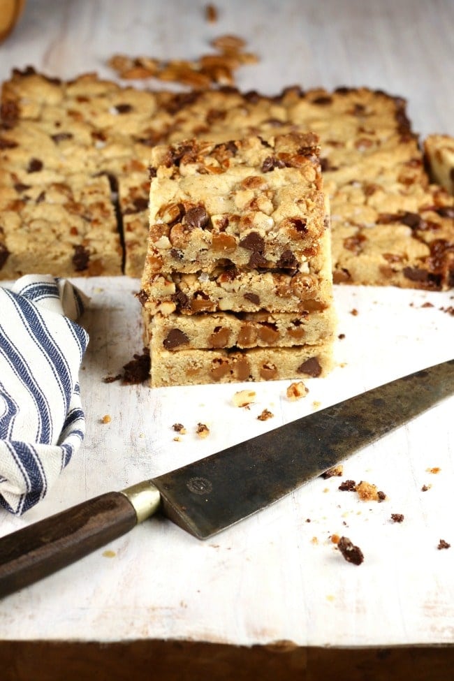 stack of salted caramel cookie bars with knife and napkin