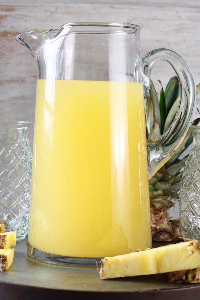 Glass Pitcher of Easy Pineapple Wine Punch with fresh pineapple wedges