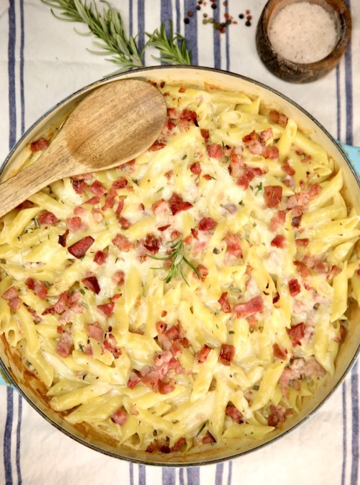 Baked ham penne pasta in a round pan.
