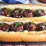 Barbecue Meatball Hoagie Sandwiches on a black platter