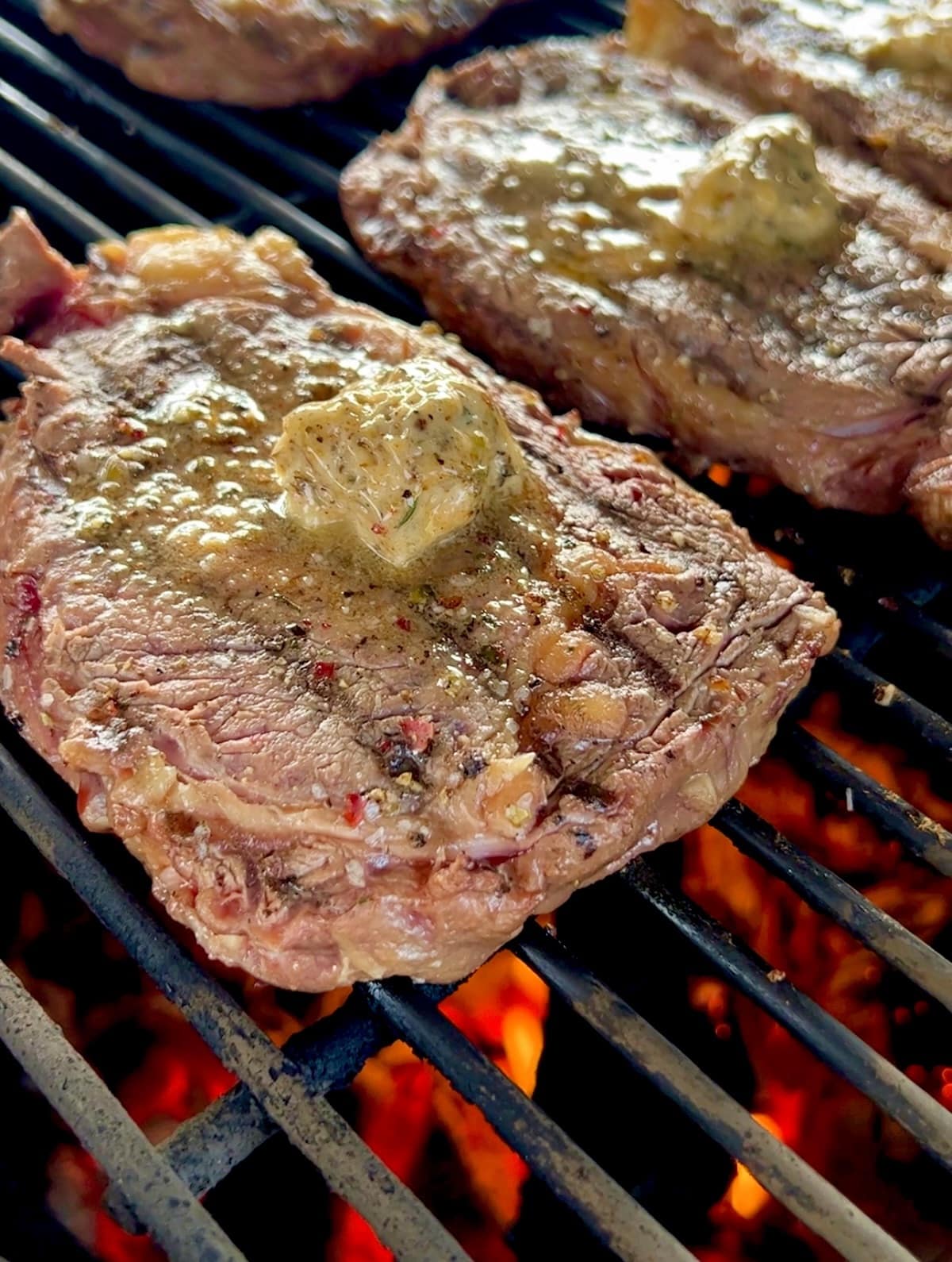Grilling steak with butter.