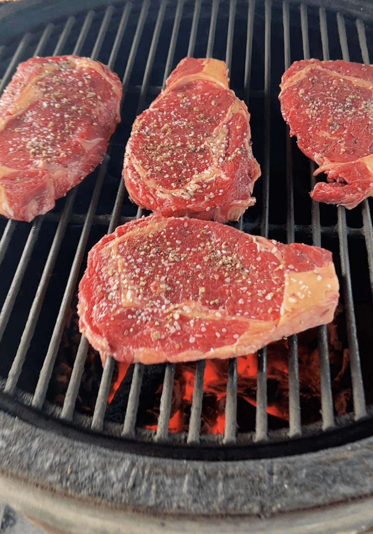 Grilling ribeye steaks.