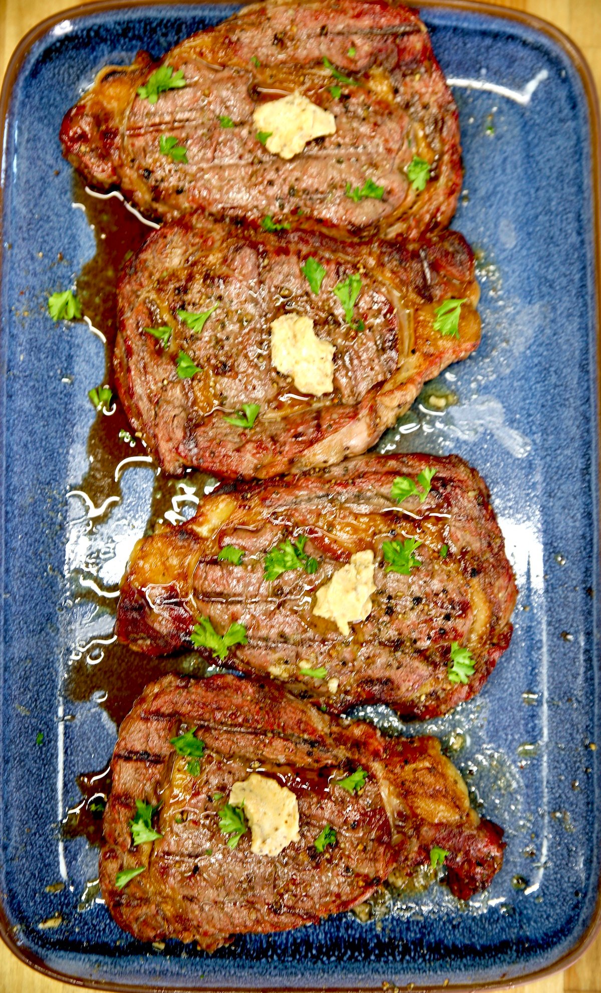 4 Ribeye steaks with garlic butter.