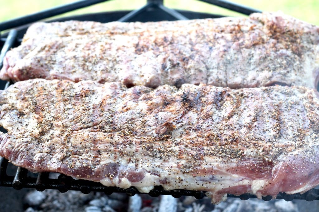 Seared spare ribs on an open wood fire grill