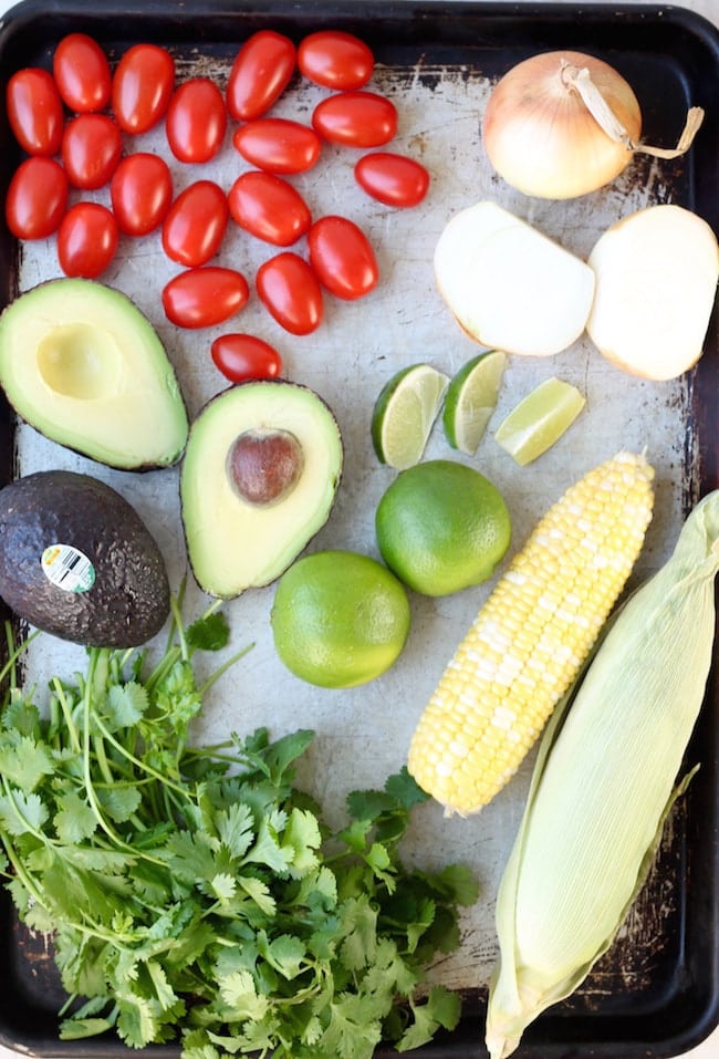 Ingredients for Mexican Street Corn: Avocados, tomatoes, limes, corn on the cob, vidalia onions, cilantro