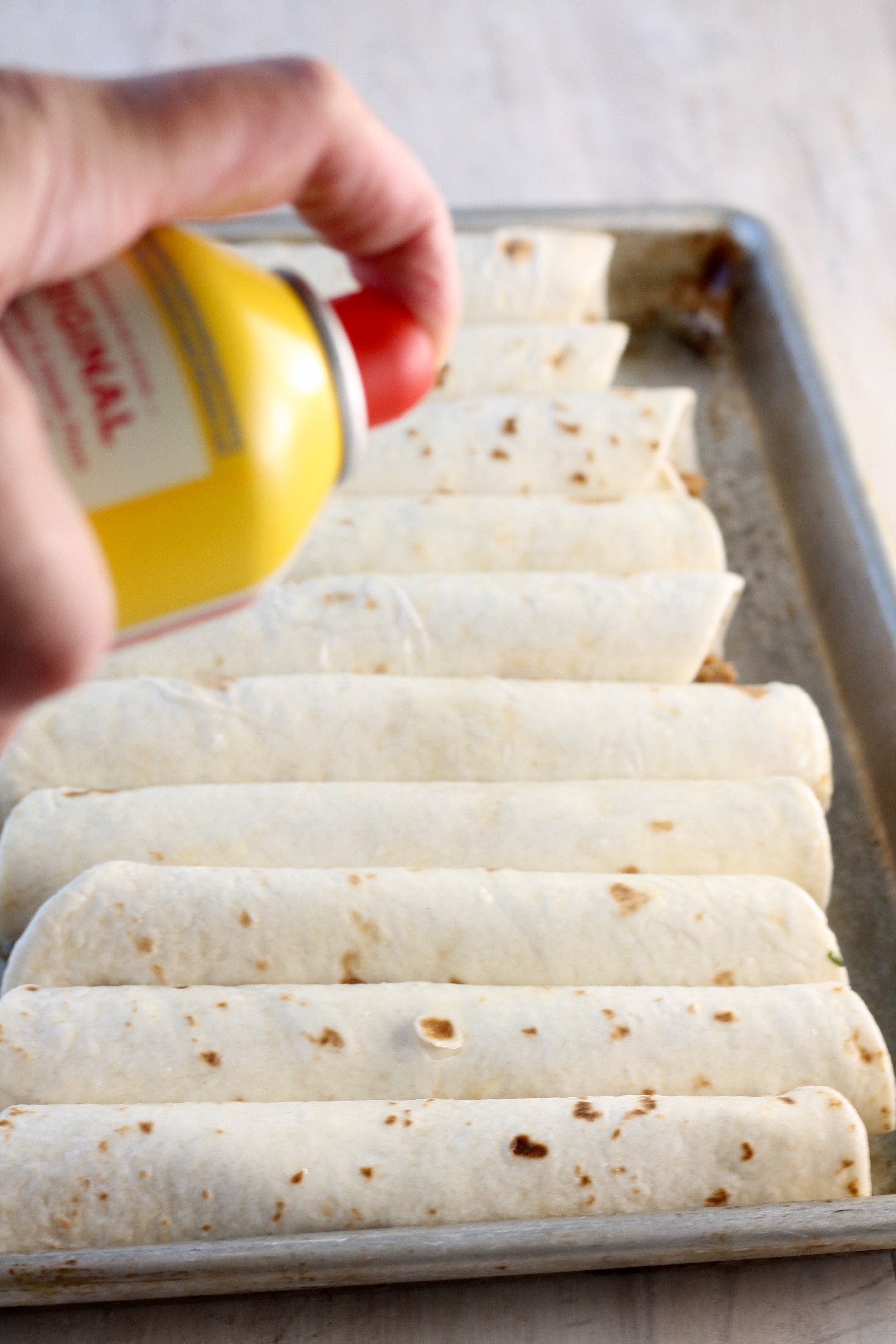 Spray brisket taquitos with non stick cooking spray to help them brown