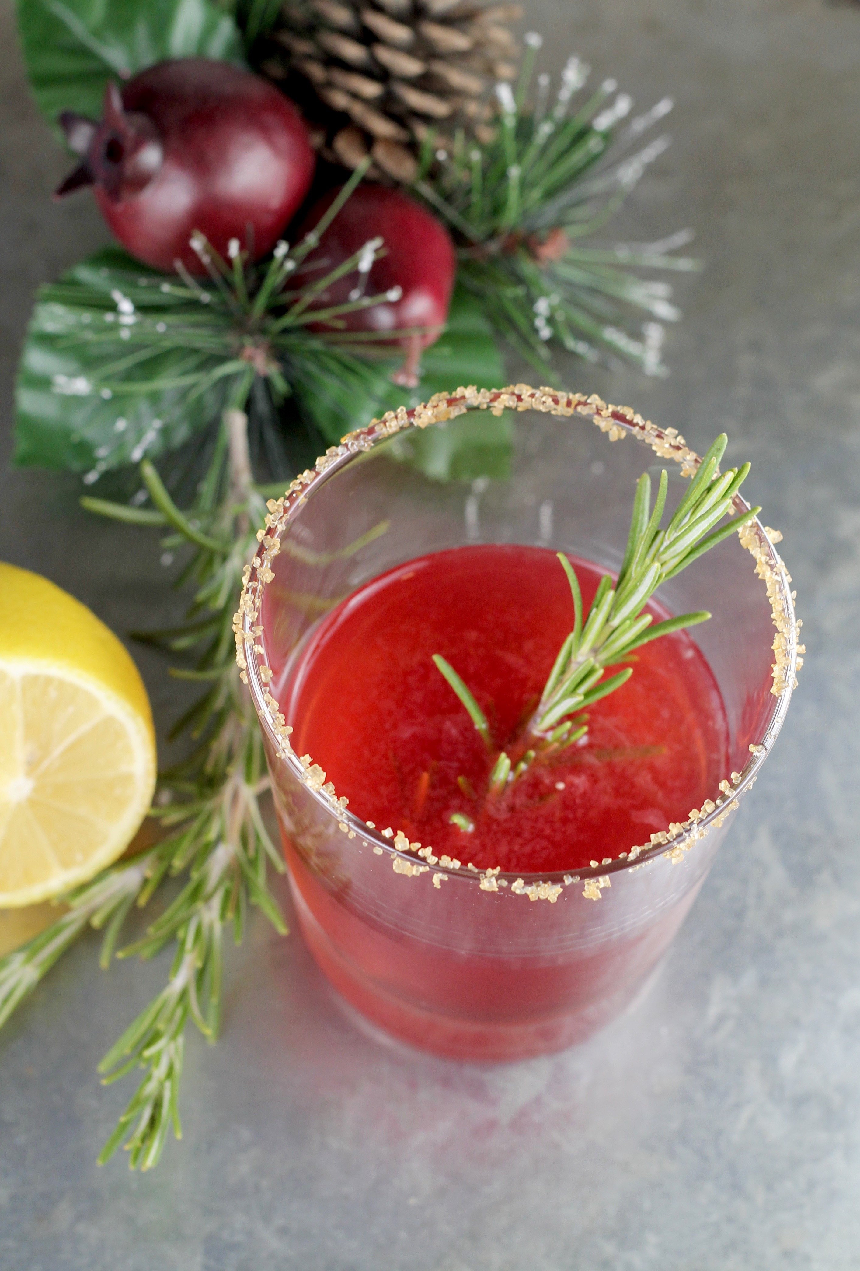 Pomegranate Sidecar Cocktail with bourbon and rosemary garnish
