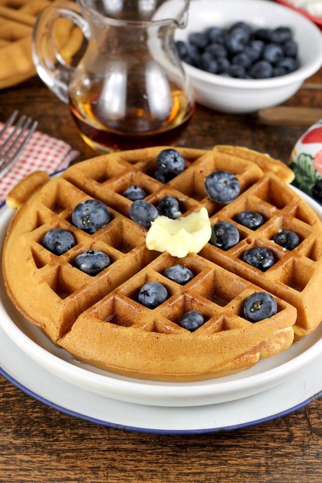 Easy Belgian Waffles topped with blueberries, butter and maple syrup