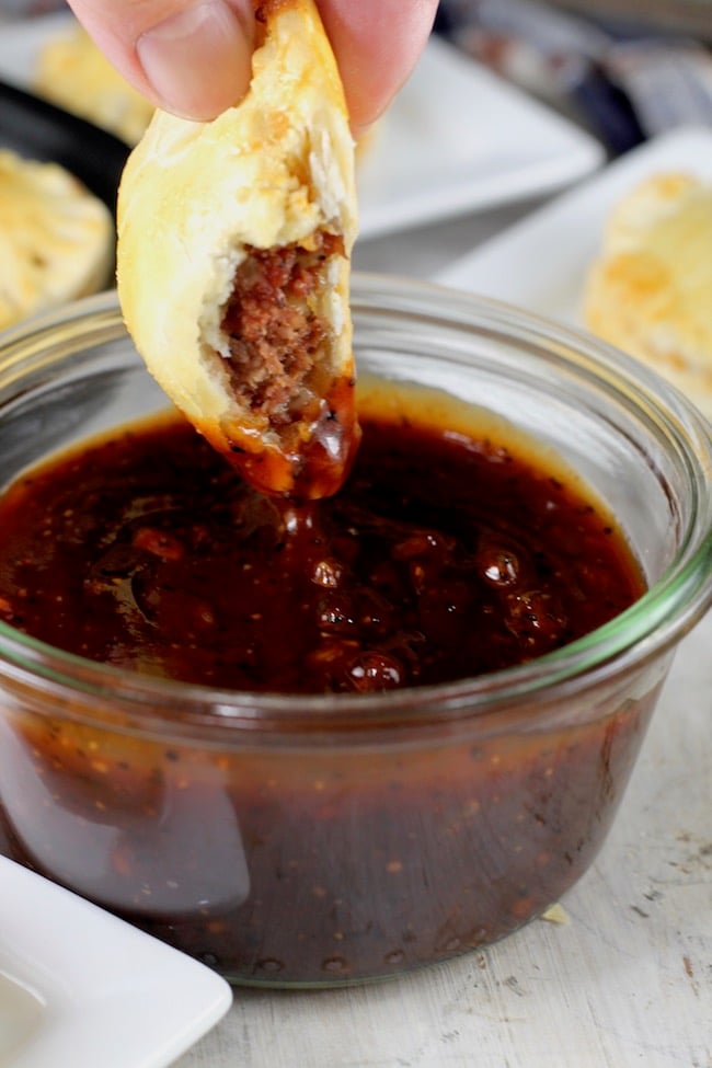 Dipping Mini Barbecue Meat Pies in homemade Barbecue Sauce