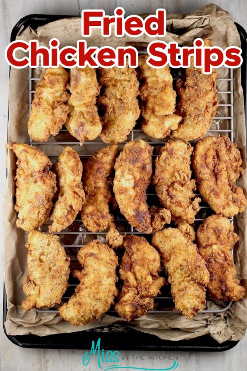 Fried chicken strips on a baking sheet.