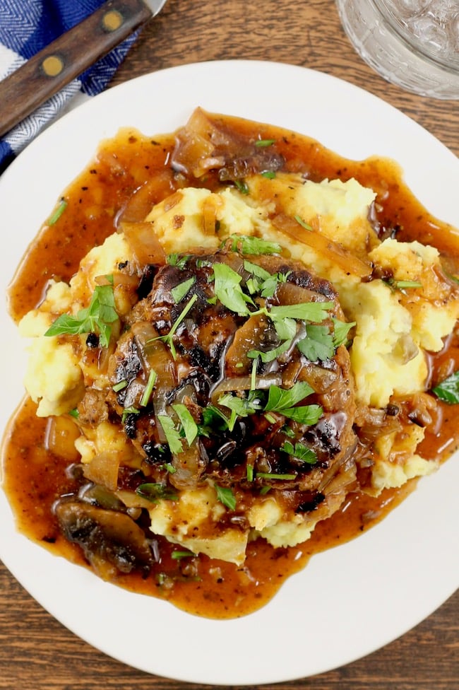 Homemade Salisbury Steak Recipe served over mashed potatoes with mushroom and onion gravy