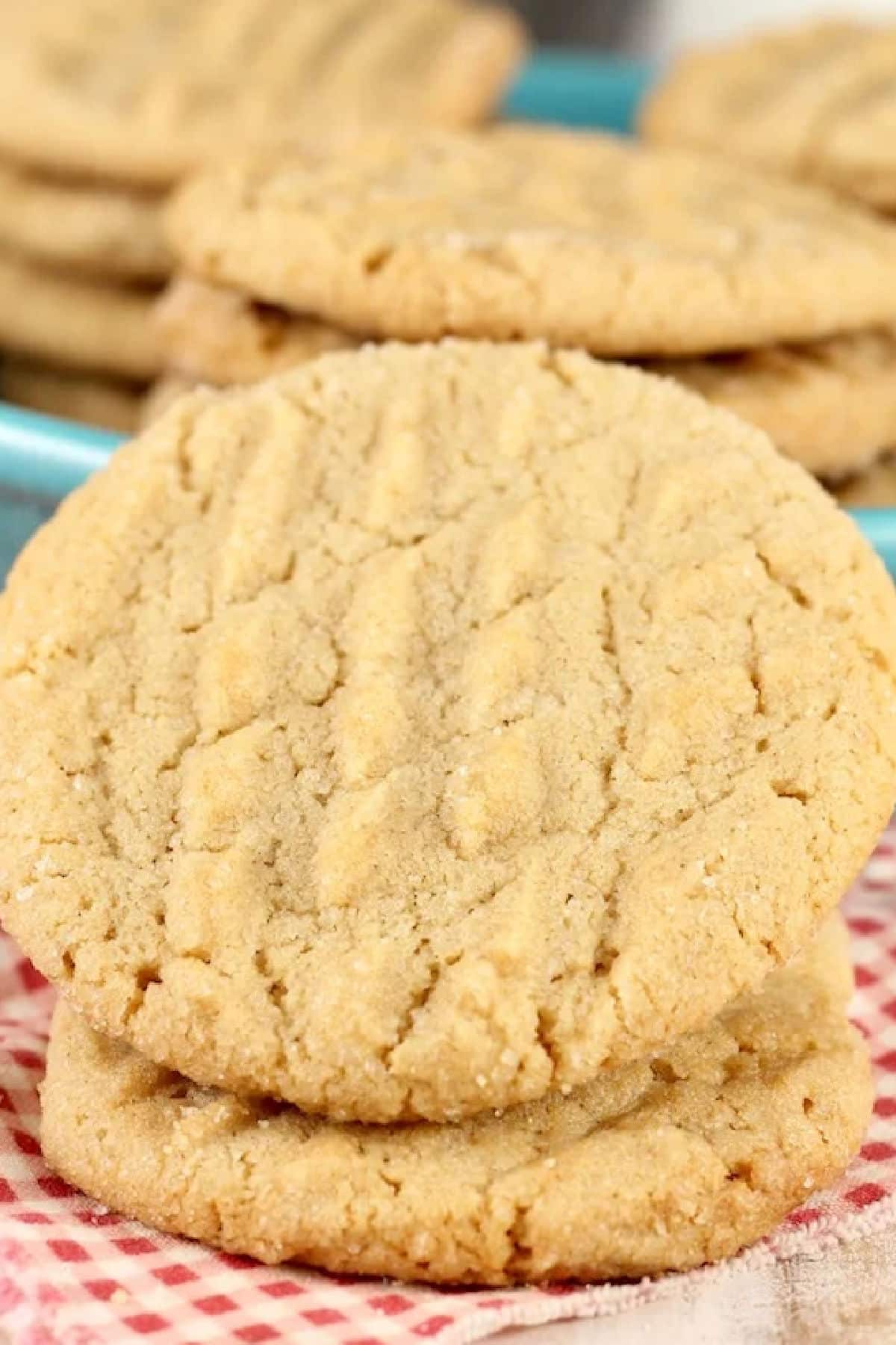 Closeup of 2 peanut butter cookies, stacked at an angle.