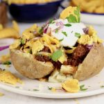 Chili Baked Potato topped with cheese, sour cream, onions and fritos