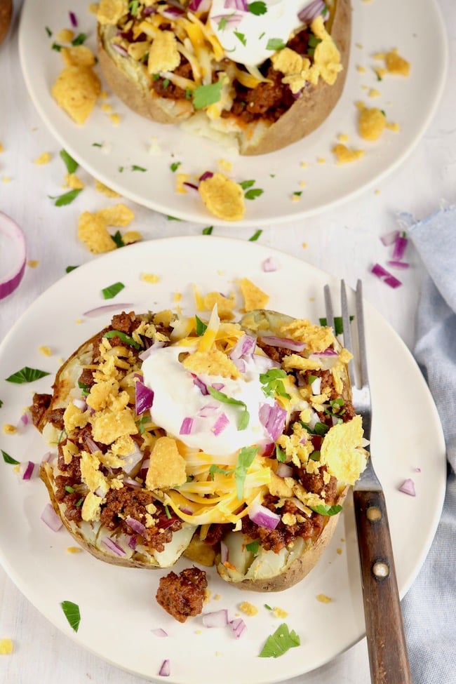 Chili Cheese Baked Potatoes with Fritos, cheese and sour cream