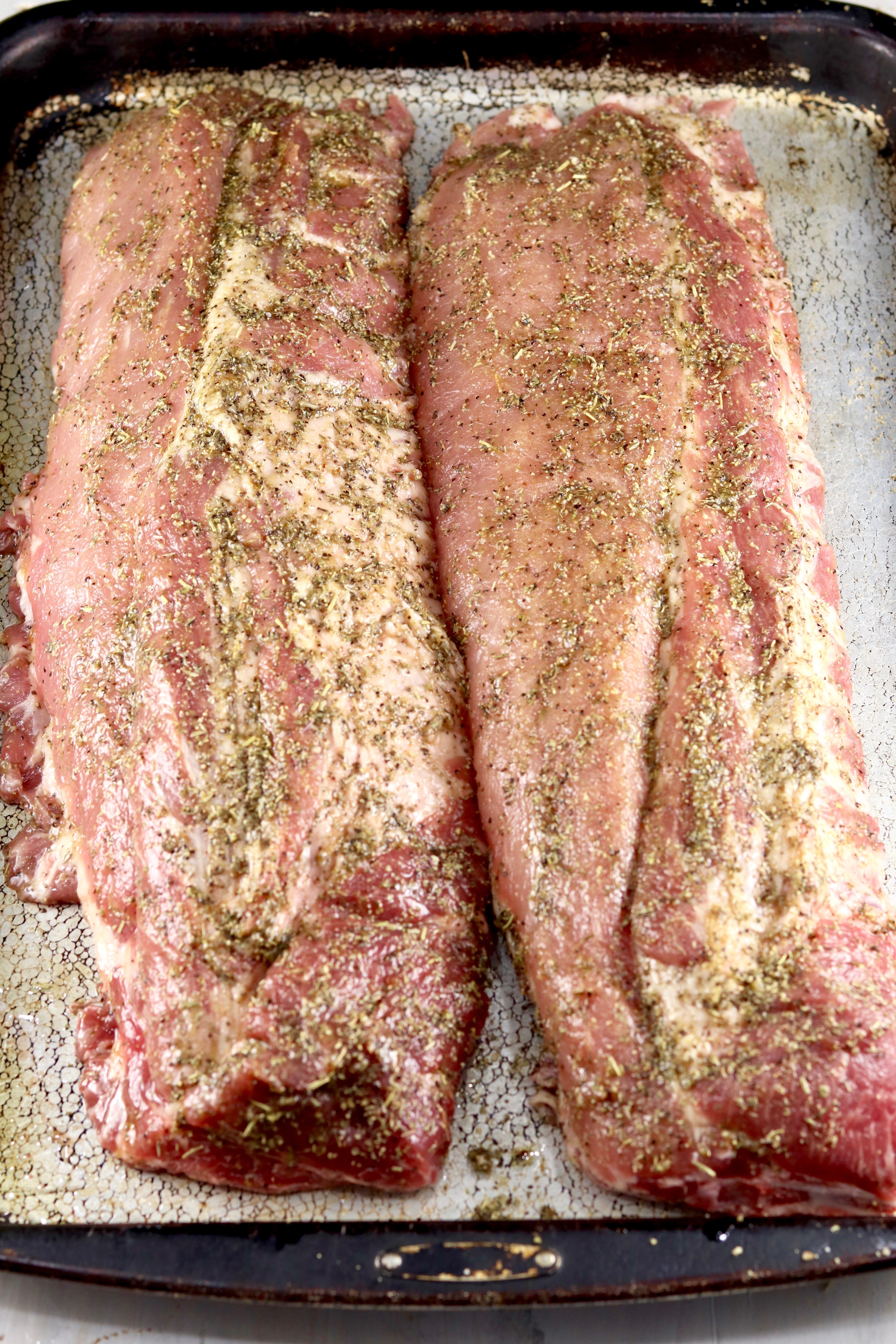 Baby Back Ribs seasoned with garlic and herb dry rub ready for the grill
