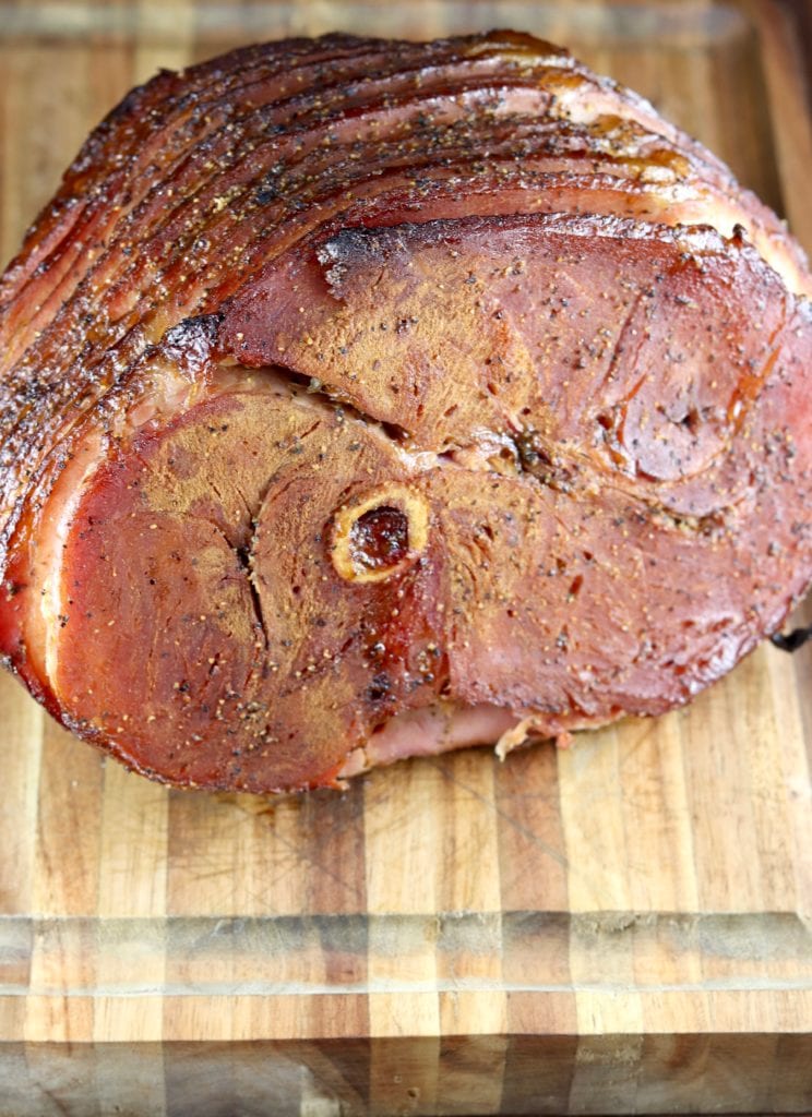 Grilled Spiral Ham with Balsamic Glaze resting on cutting board