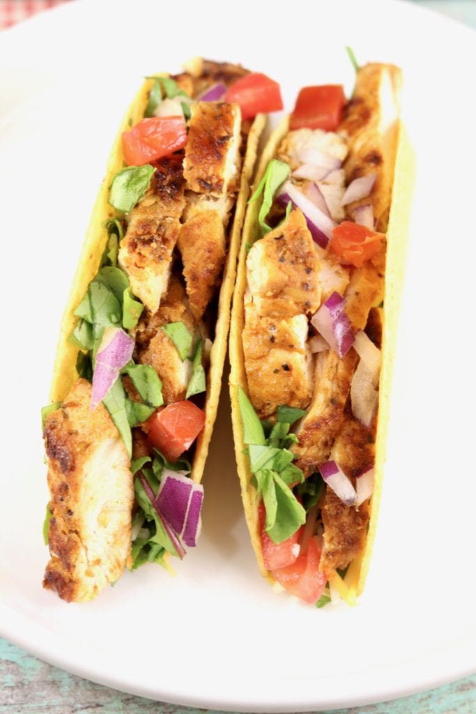 Blackened Chicken Tacos with tomatoes, lettuce and red onion