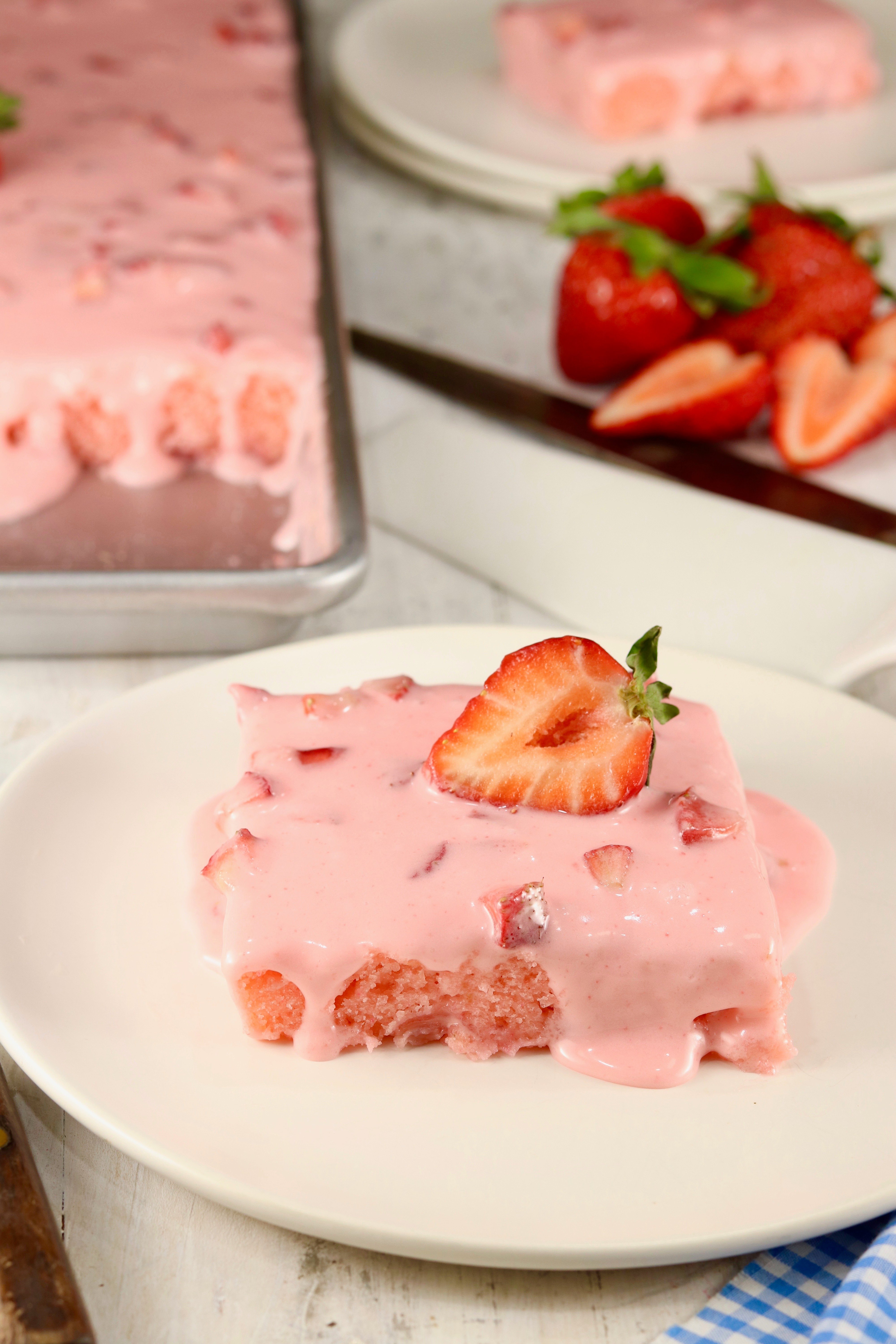 Slice of Strawberry Cake with strawberry cream cheese frosting