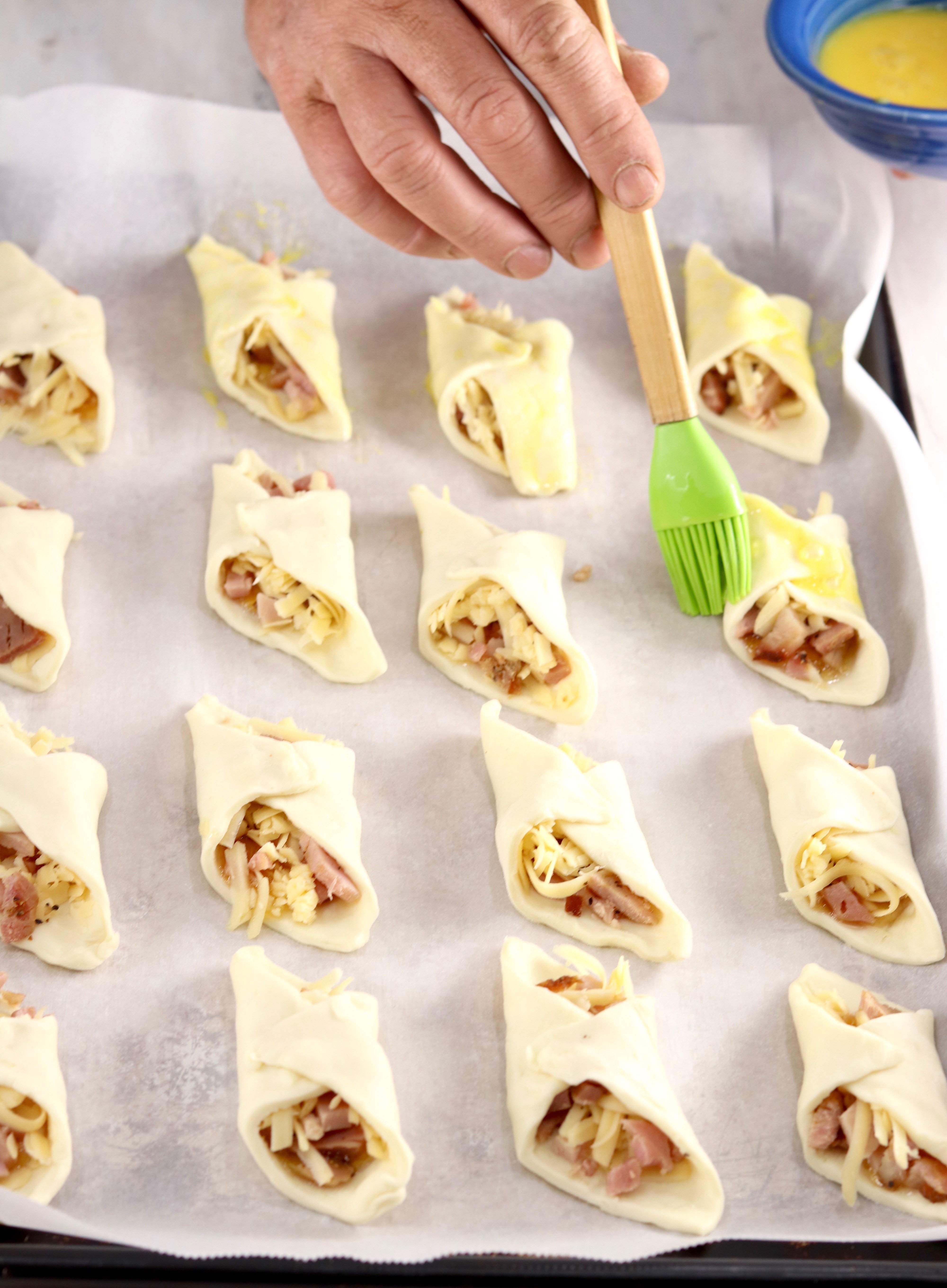 Brushing Puff Pastry Appetizers with egg before baking