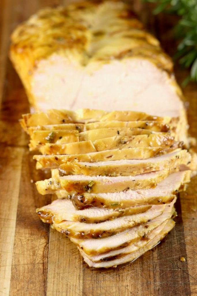 Sliced Mustard BBQ Chicken breast on wood board
