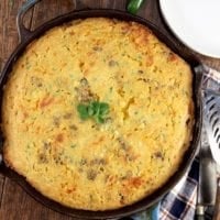 Mexican Cornbread with ground beef and cheese in an iron skillet