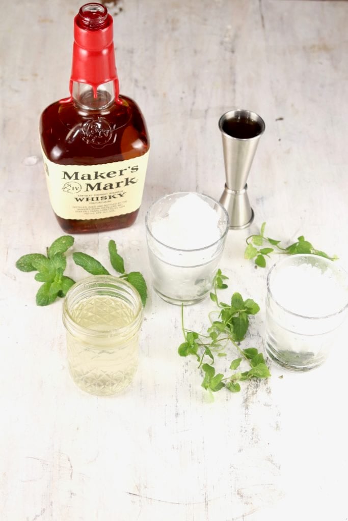 Makers Mark Bourbon, simple syrup and fresh mint, glasses of ice