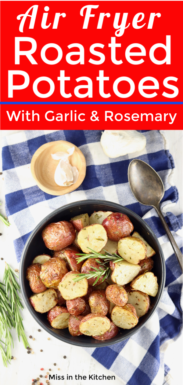 Baby Potatoes roasted with garlic and rosemary in a bowl, blue check napkin, and serving spoon