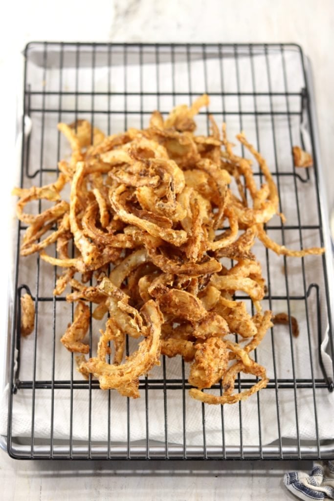Fried Onion Strings on a wire rack