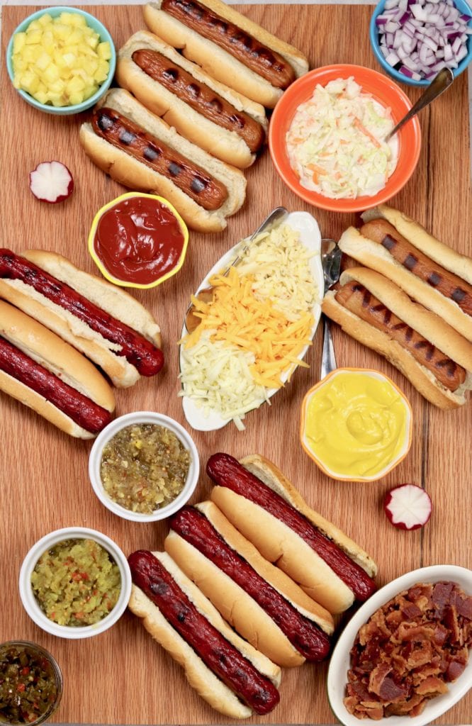 Grilled Hot Dogs with relish, bacon, mustard, slaw, and pineapples