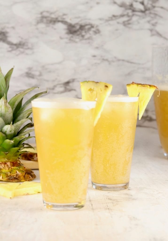 Beer Punch in glasses with fresh pineapple garnish