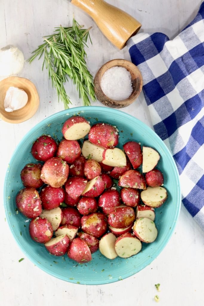 Bowl of baby red potatoes with salt, garlic and rosemary
