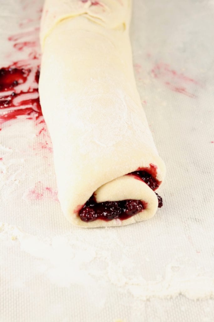 Sweet roll dough roll up with blackberry filling
