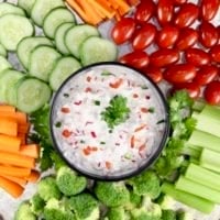 Creamy Dip with cut up carrots, cucumbers, broccoli, and grape tomatoes on a platter