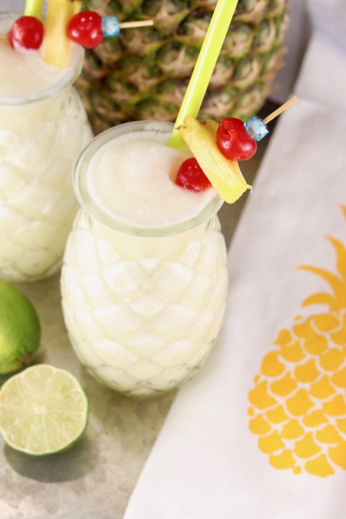 Overhead of pina colada garnished with cherry and pineapple