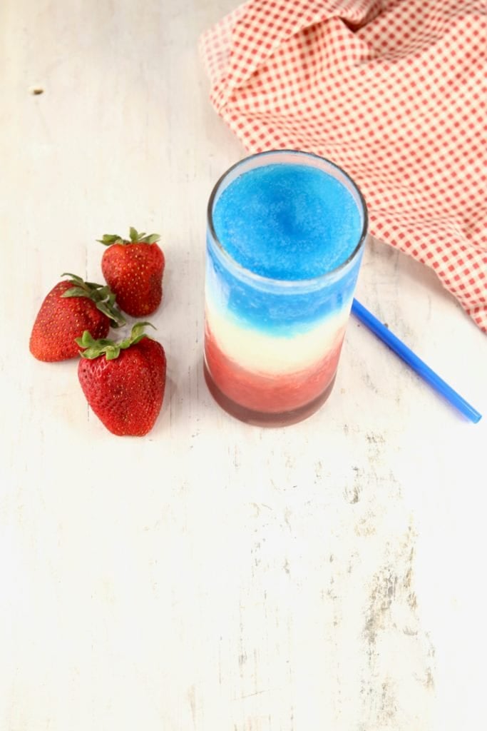 Frozen red, white and blue drink with fresh strawberries
