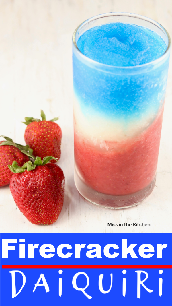 Layered frozen rum cocktail, red, white and blue daiquiri with fresh strawberries, text overlay on bottom