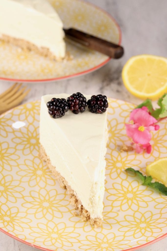 Slice of lemon cheesecake on a yellow plate