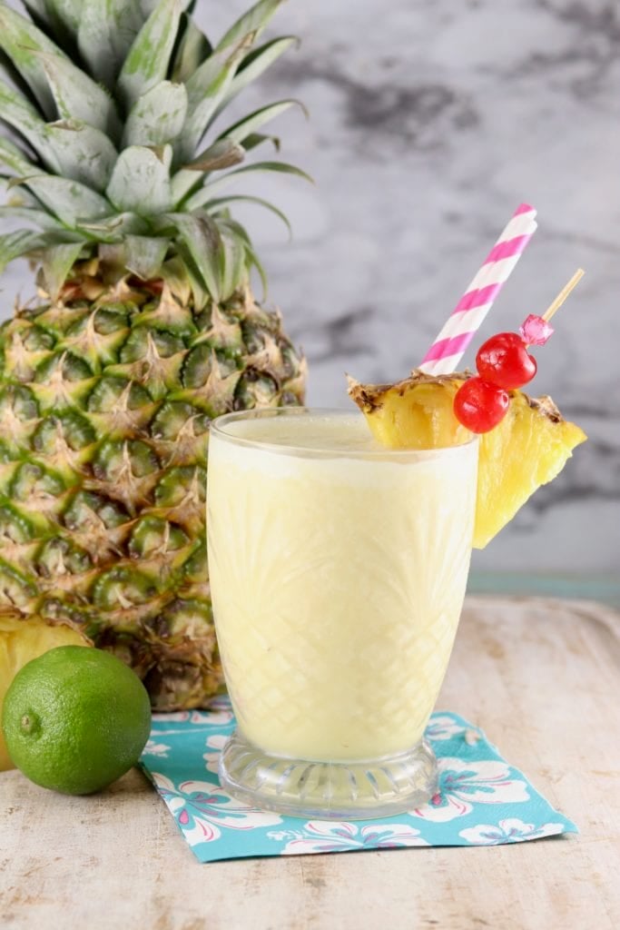 PIna Colada Mocktail with a fresh pineapple to the side
