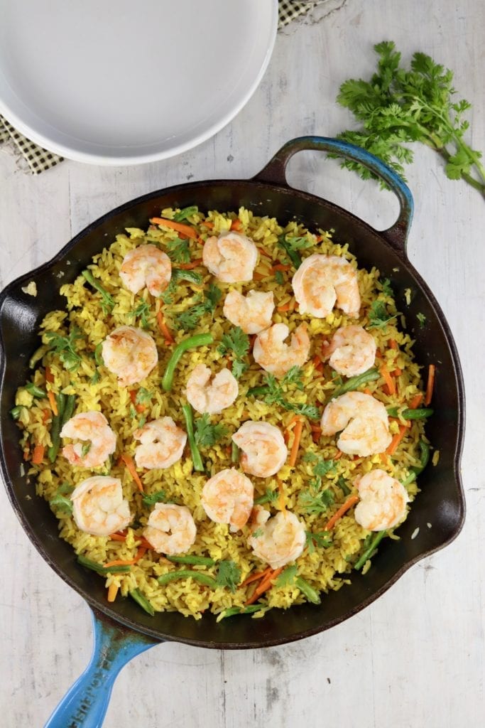 Cast iron skillet with fried rice with shrimp