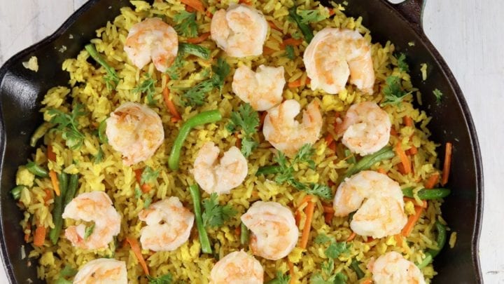 Cast iron skillet with fried rice with shrimp