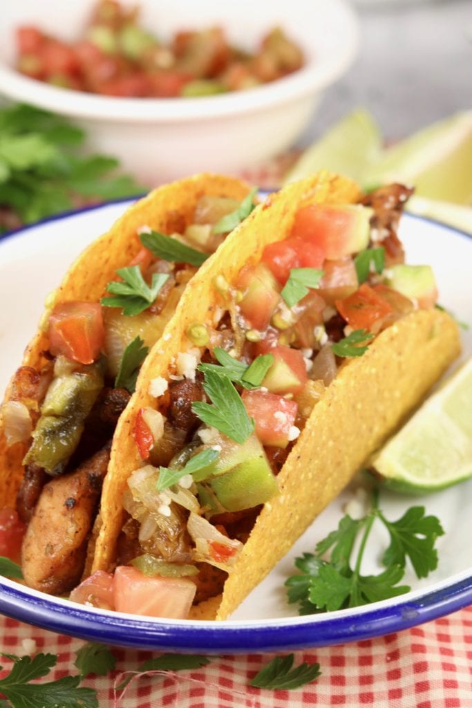Crunchy corn tortilla tacos with fish and tomatoes