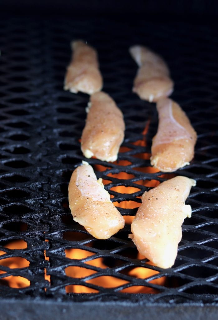 Chicken tenders on a wood fired grill