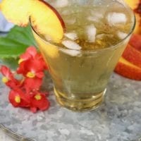 Peach Old Fashioned Cocktail garnished with a fresh peach slice