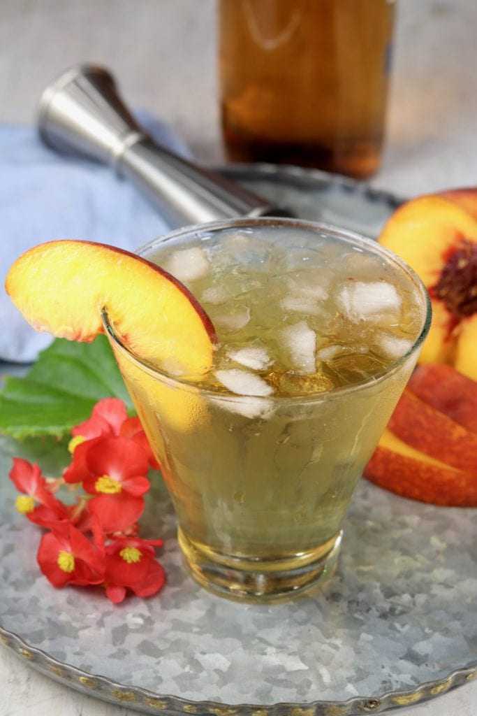Old fashioned cocktail with bourbon and peach schnapps